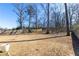 Large, unfenced backyard with mature trees and play swing at 333 Gardens Of Harmony Dr, Canton, GA 30115