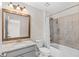 Well-lit bathroom featuring a granite vanity, framed mirror, and shower-tub combo at 333 Gardens Of Harmony Dr, Canton, GA 30115