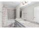 Well-lit bathroom with shower-tub combo and granite vanity at 333 Gardens Of Harmony Dr, Canton, GA 30115