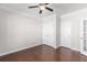 Bedroom with a ceiling fan, hardwood floors, closet, and a door offers practical elegance at 333 Gardens Of Harmony Dr, Canton, GA 30115