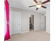 A carpeted bedroom has neutral walls, a window, and a view into a bathroom at 333 Gardens Of Harmony Dr, Canton, GA 30115