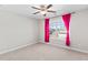 Cozy bedroom featuring neutral walls, carpet, and a window with vibrant pink curtains at 333 Gardens Of Harmony Dr, Canton, GA 30115