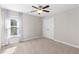 This bedroom has neutral walls, carpet floors, a ceiling fan and a double door closet at 333 Gardens Of Harmony Dr, Canton, GA 30115