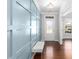 Inviting entryway with blue paneled wall, a light fixture, and a tufted bench over hardwood floors at 333 Gardens Of Harmony Dr, Canton, GA 30115