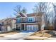 Traditional two-story home with a brick and siding exterior, a well-manicured lawn, and a spacious driveway at 333 Gardens Of Harmony Dr, Canton, GA 30115