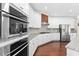 Modern kitchen featuring stainless steel appliances, granite countertops, and sleek white cabinetry at 333 Gardens Of Harmony Dr, Canton, GA 30115