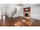 Open concept living room with hardwood floors, stone fireplace, and entryway for easy flow at 333 Gardens Of Harmony Dr, Canton, GA 30115