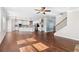 Open concept living space with hardwood floors seamlessly connects the living room and kitchen at 333 Gardens Of Harmony Dr, Canton, GA 30115