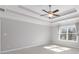 This primary bedroom features trey ceilings, neutral walls, carpet floors, and a window at 333 Gardens Of Harmony Dr, Canton, GA 30115