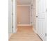 Light-filled hallway with wood-look floors and neutral walls at 407 Coleraine Se, Smyrna, GA 30080