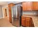 Stainless steel refrigerator in kitchen with wood cabinets at 407 Coleraine Se, Smyrna, GA 30080