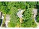 Aerial view of a house nestled in a lush, wooded area with a pool and patio at 5236 Weatherwood Trce, Marietta, GA 30068