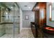 Bathroom with double vanity, walk-in shower, and dark wood cabinets at 5236 Weatherwood Trce, Marietta, GA 30068