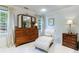 Serene bedroom with tufted chaise lounge and wood dresser at 5236 Weatherwood Trce, Marietta, GA 30068