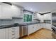 White kitchen with granite countertops and stainless steel appliances at 5236 Weatherwood Trce, Marietta, GA 30068