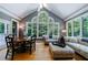 Bright sunroom with hardwood floors, vaulted ceiling, and large windows at 5236 Weatherwood Trce, Marietta, GA 30068