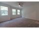 Bright bedroom with carpet, three windows, and ceiling fan at 706 Dodd Ln # 157, Buford, GA 30518