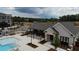 Community pool and clubhouse with surrounding landscape at 706 Dodd Ln # 157, Buford, GA 30518