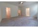 Spacious main bedroom with plush carpeting, ceiling fan and ensuite bathroom at 706 Dodd Ln # 157, Buford, GA 30518