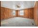 Spacious bedroom with wood paneling and carpet flooring at 1265 Glenbrooke Cv, Lawrenceville, GA 30045