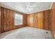 Simple bedroom with wood paneling, carpet, and double closets at 1265 Glenbrooke Cv, Lawrenceville, GA 30045