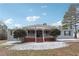 Ranch-style home with covered porch and landscaped yard at 1265 Glenbrooke Cv, Lawrenceville, GA 30045