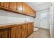 Laundry room with wood cabinets, countertop, and exterior access at 1265 Glenbrooke Cv, Lawrenceville, GA 30045