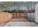 Backyard view of the fenced-in yard, small grass area, and concrete patio at 2320 Whitestone Pl, Alpharetta, GA 30005