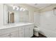 Bathroom featuring double vanity with modern lighting and separate tub with tile surround at 2320 Whitestone Pl, Alpharetta, GA 30005