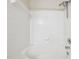 Bathroom features a tub with a white tile surround and a modern shower head at 2320 Whitestone Pl, Alpharetta, GA 30005