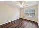 Bright bedroom with modern ceiling fan, beautiful dark wood floor, and natural light from the window at 2320 Whitestone Pl, Alpharetta, GA 30005