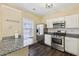 Updated kitchen boasts stainless steel appliances and granite counters at 2320 Whitestone Pl, Alpharetta, GA 30005