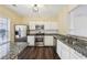 Modern kitchen with stainless steel appliances, granite countertops, and white cabinetry at 2320 Whitestone Pl, Alpharetta, GA 30005