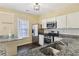 Well-lit kitchen featuring stainless steel appliances and granite countertops at 2320 Whitestone Pl, Alpharetta, GA 30005