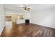 Hardwood floor living room with fireplace and view of the eat-in kitchen area at 2320 Whitestone Pl, Alpharetta, GA 30005