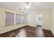 Spacious main bedroom with hardwood floors, ceiling fan and bathroom access at 2320 Whitestone Pl, Alpharetta, GA 30005