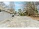 A concrete patio leads to a brick exterior with bare trees and foliage at 250 Hermer Nw Cir, Atlanta, GA 30311