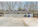 The backyard offers a concrete patio with a grey brick exterior and a grey roof at 250 Hermer Nw Cir, Atlanta, GA 30311