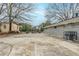 A concrete backyard patio features brick exteriors and barren winter trees at 250 Hermer Nw Cir, Atlanta, GA 30311