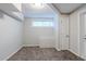 Cozy carpeted basement features a window for natural light and easy access to the entry door at 250 Hermer Nw Cir, Atlanta, GA 30311