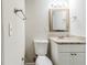 Traditional bathroom with granite countertop, toilet, vanity and updated fixtures at 250 Hermer Nw Cir, Atlanta, GA 30311