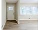 Bright living room featuring new floors, large windows, and neutral paint at 250 Hermer Nw Cir, Atlanta, GA 30311