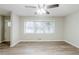 Open living room with new floors, a ceiling fan, a doorway and bright windows at 250 Hermer Nw Cir, Atlanta, GA 30311