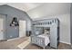 Blue painted bedroom showcasing a unique, gray bunk bed, blue accent wall and gray carpet at 2625 Lake Erma Dr, Hampton, GA 30228