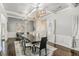 Beautiful dining room featuring coffered ceilings, hardwood floors, and statement lighting at 2625 Lake Erma Dr, Hampton, GA 30228