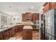 Open kitchen featuring stainless steel appliances, granite countertops, and dark wood cabinetry at 2625 Lake Erma Dr, Hampton, GA 30228