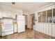 White kitchen with appliances, and a view into another room at 3310 Chisholm Sw Trl, Marietta, GA 30060