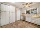 Bright kitchen with white cabinets, stainless steel dishwasher, and vinyl flooring at 3310 Chisholm Sw Trl, Marietta, GA 30060