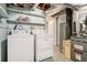 Basement laundry room with washer, dryer, and shelving at 3310 Chisholm Sw Trl, Marietta, GA 30060