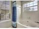 Bathroom featuring a shower/tub combo and window at 3815 Landcraf Cv, Decatur, GA 30034